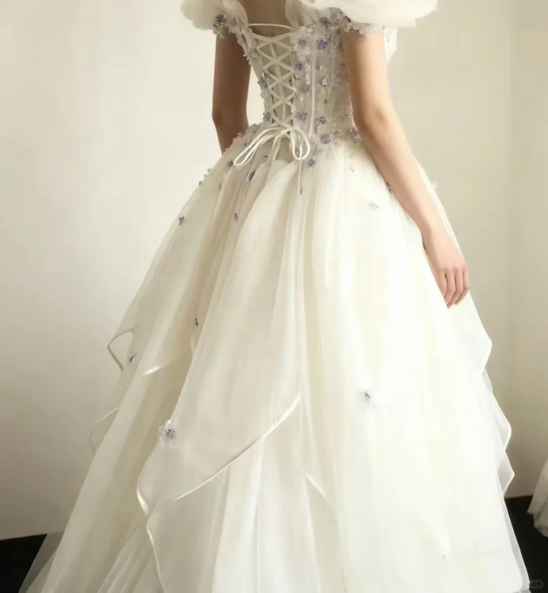 Off‑the‑Shoulder Ball Gown Wedding Dress, Puff Short Sleeve Corset Bodice 3D Purple Floral Applique Ruffled Satin‑Trim Tulle Skirt Bridal Gown gh9117
