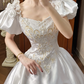 White Vintage Satin Wedding Ball Gown, Sweetheart Square Neck, Short Puff Sleeves, Gold‑Thread Lace Appliqué Pointed Waist, Voluminous A‑Line Skirt With Ruffle Lace Hem, Prom Dress gh8649